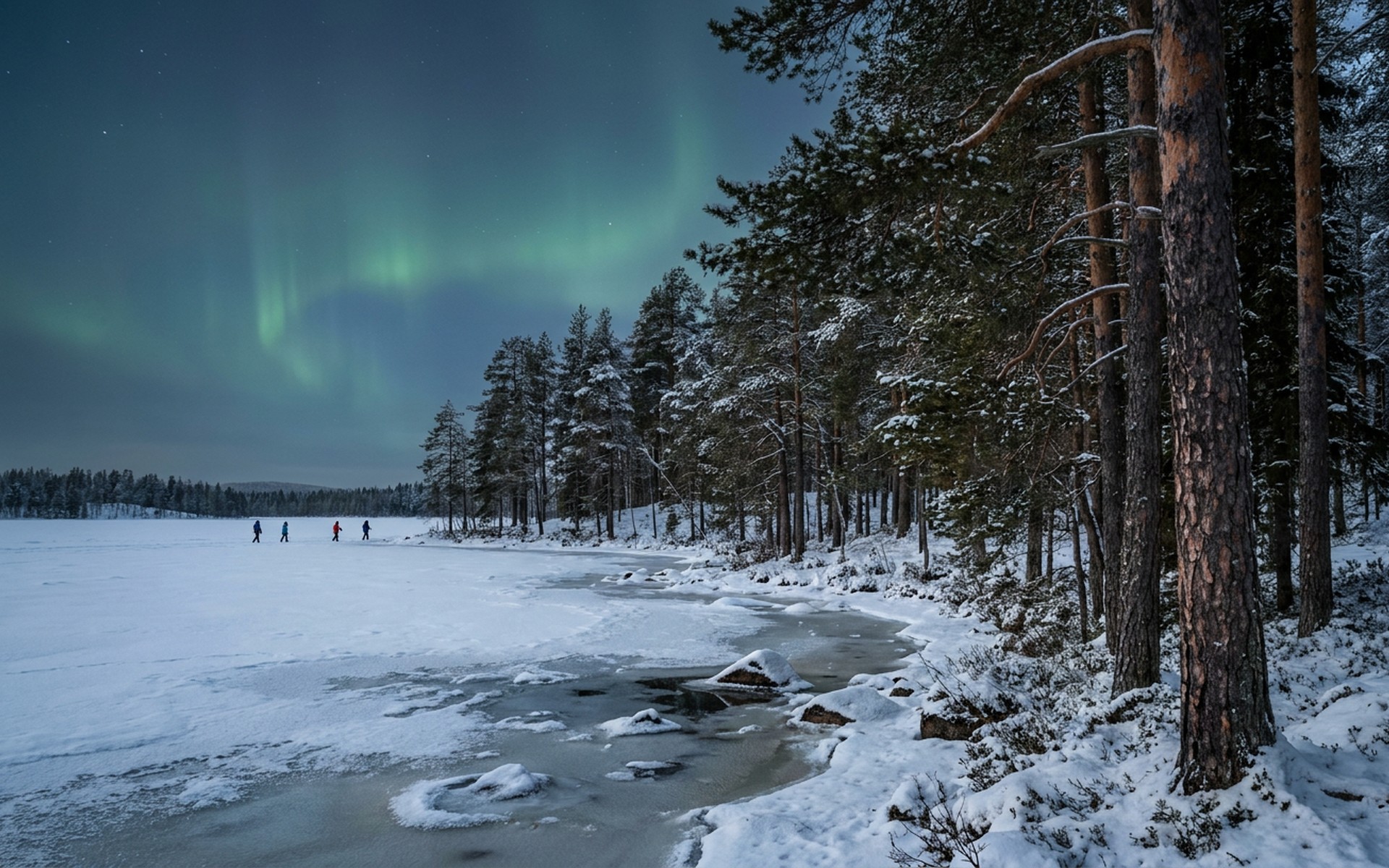 Snow-covered pine trees along a frozen lake shore under the ethereal glow of the Northern Lights in the Finnish Lapland. at Ruka & Kuusamo, Finland — original Triple VIP destination visual.