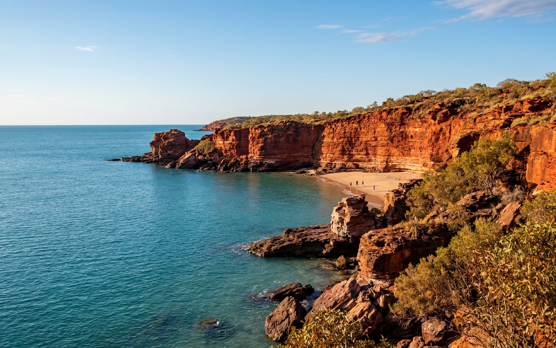Dramatic red sandstone cliffs and intricate horizontal rock formations contrasting with the turquoise Indian Ocean along the rugged Kimberley Coast. at Kimberley Coast, Australia — original Triple VIP destination visual.