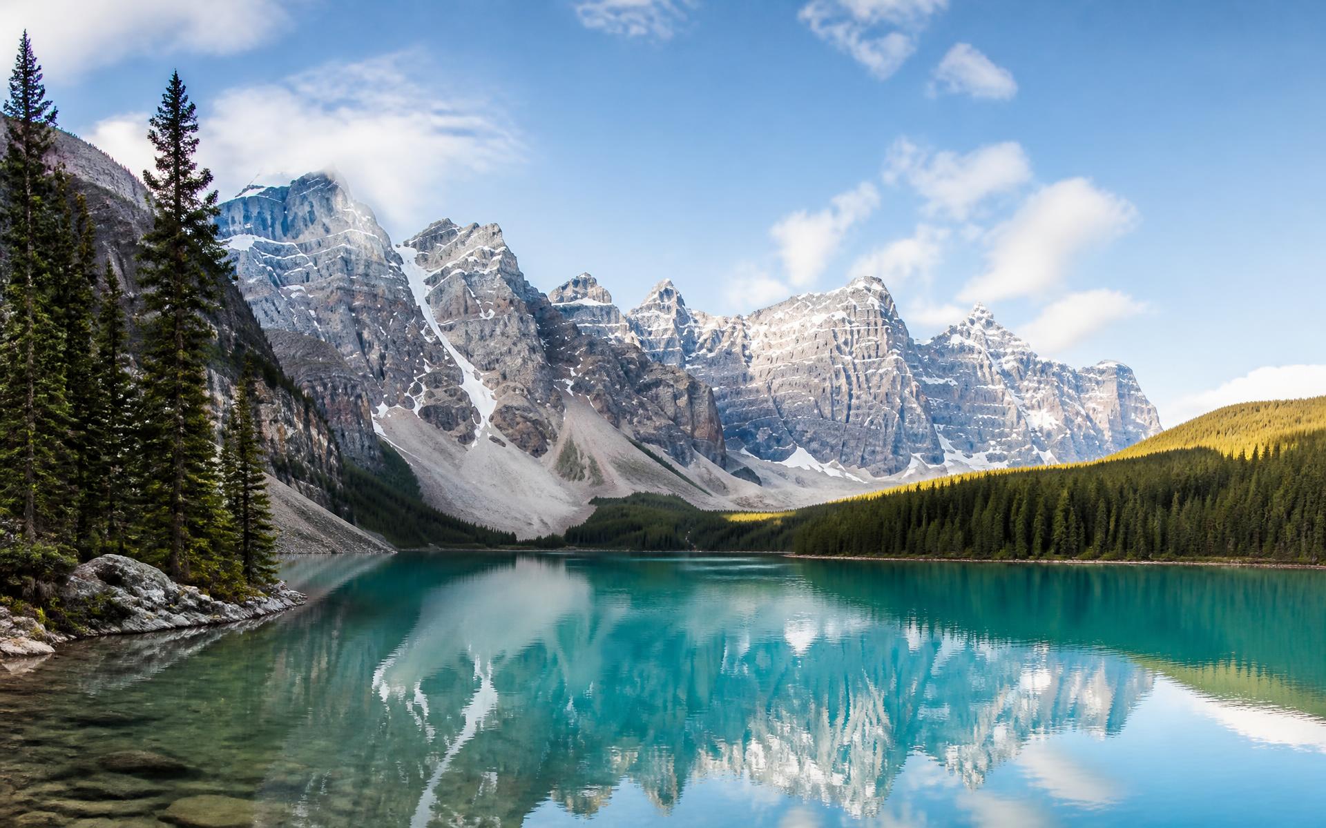 Turquoise glacial lake mirroring snow-capped Rocky Mountain peaks near Banff and Lake Louise, Canada