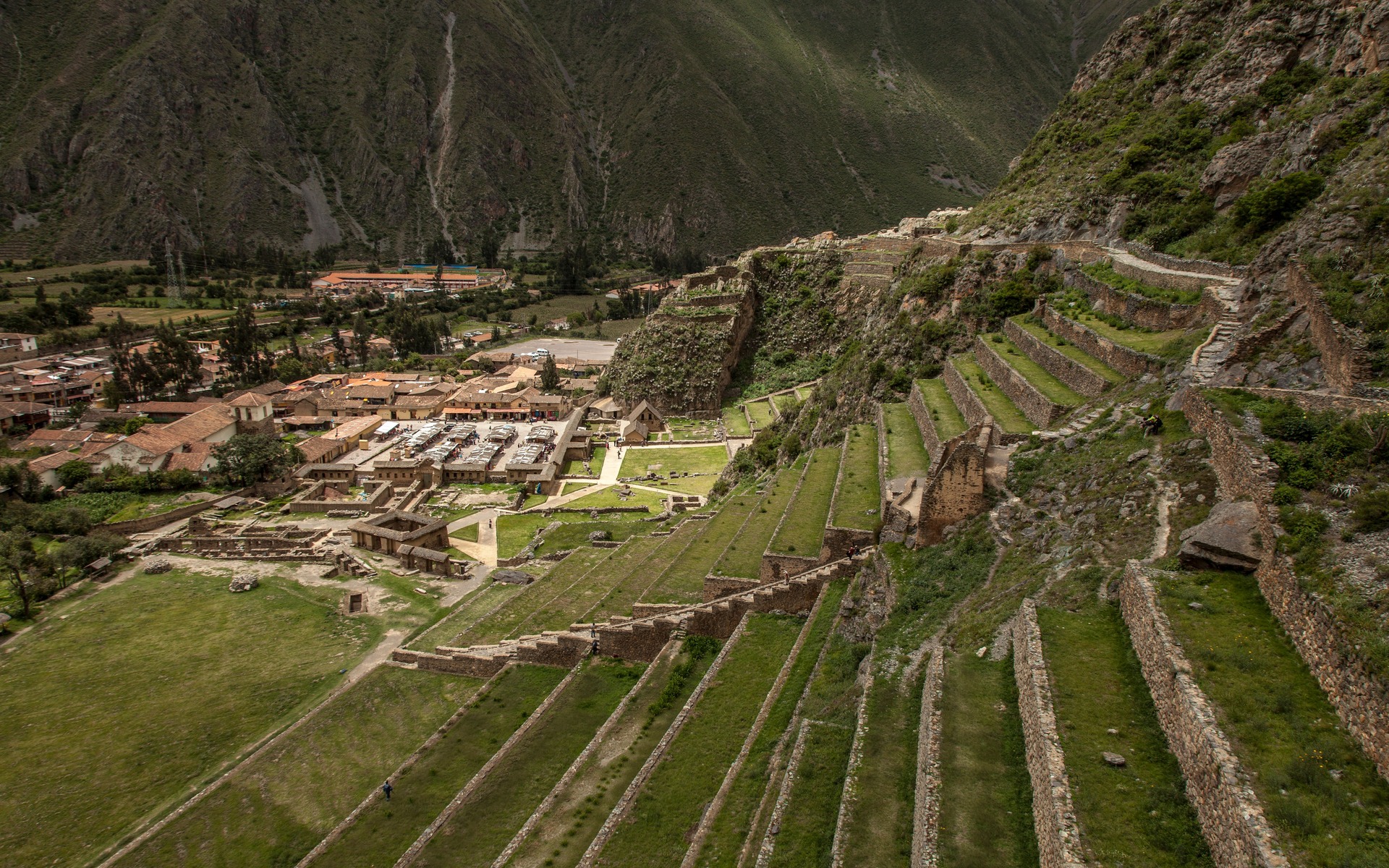 Explore the ancient Incan terraces of Ollantaytambo in Peru, captured in a stunning aerial view.