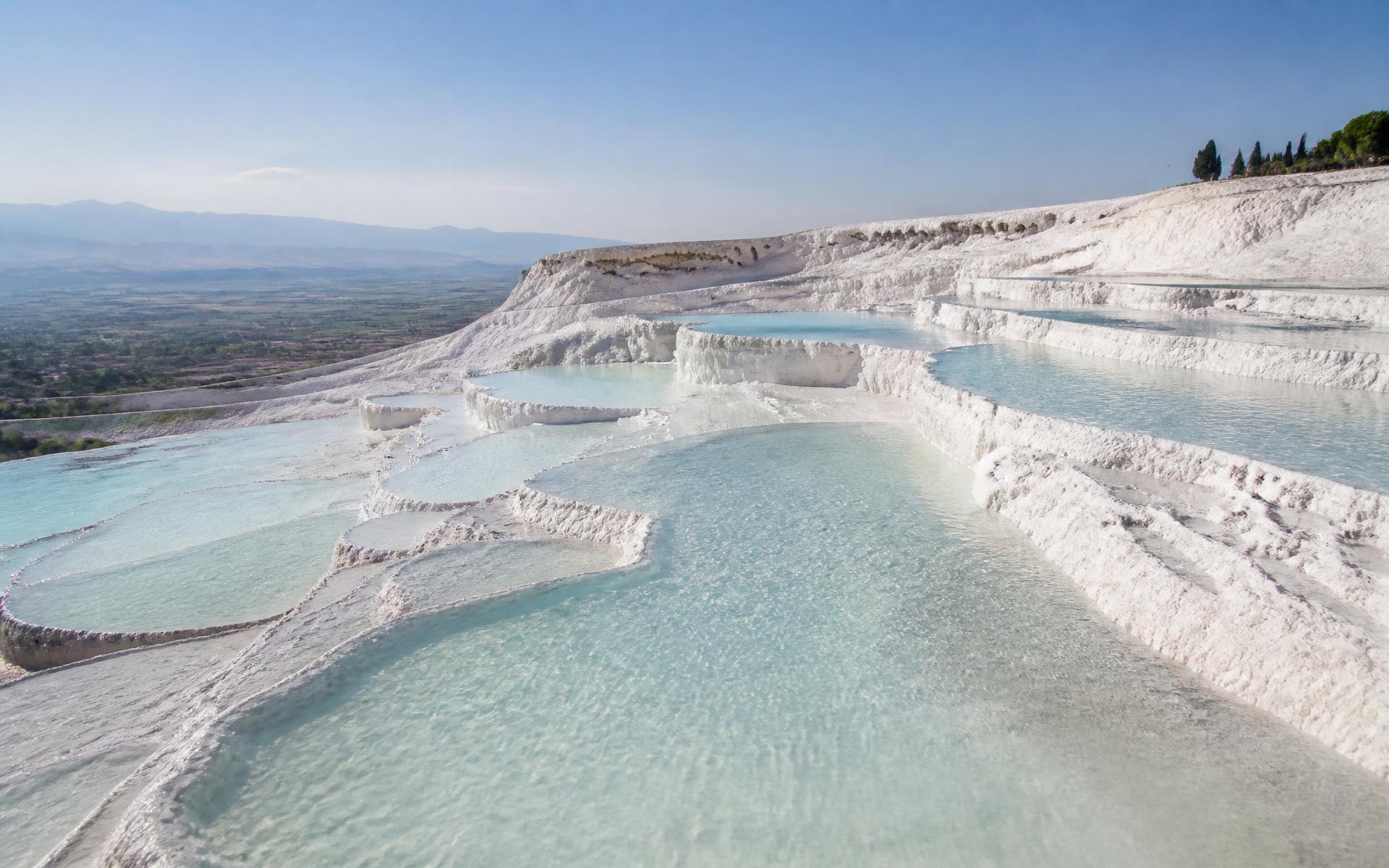 White travertine terraces filled with turquoise thermal water at Pamukkale, Turkey