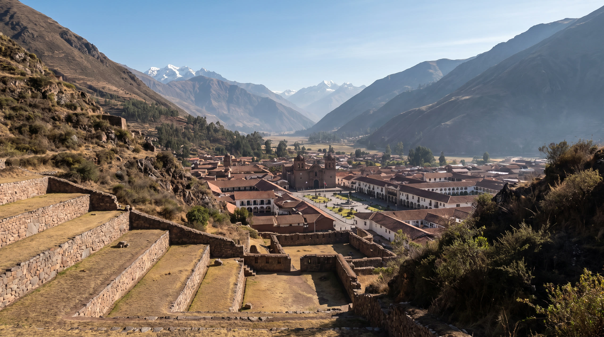 Inca terraces stepping down an Andean valley with a colonial town below at Cusco & the Sacred Valley, Peru, in morning light — original Triple VIP destination visual.