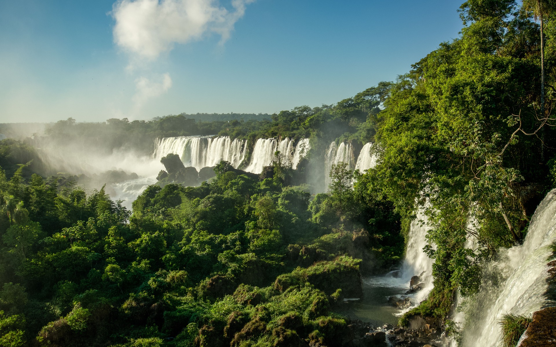 Stunning view of Iguazu Falls cascading through lush rainforest in Misiones, Argentina.