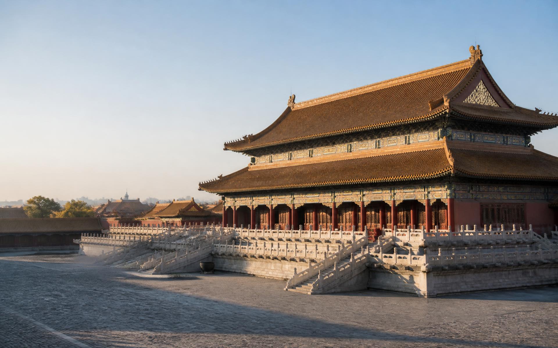 Tiered vermilion halls and golden roofs of the Forbidden City above a wide stone courtyard in Beijing at first light