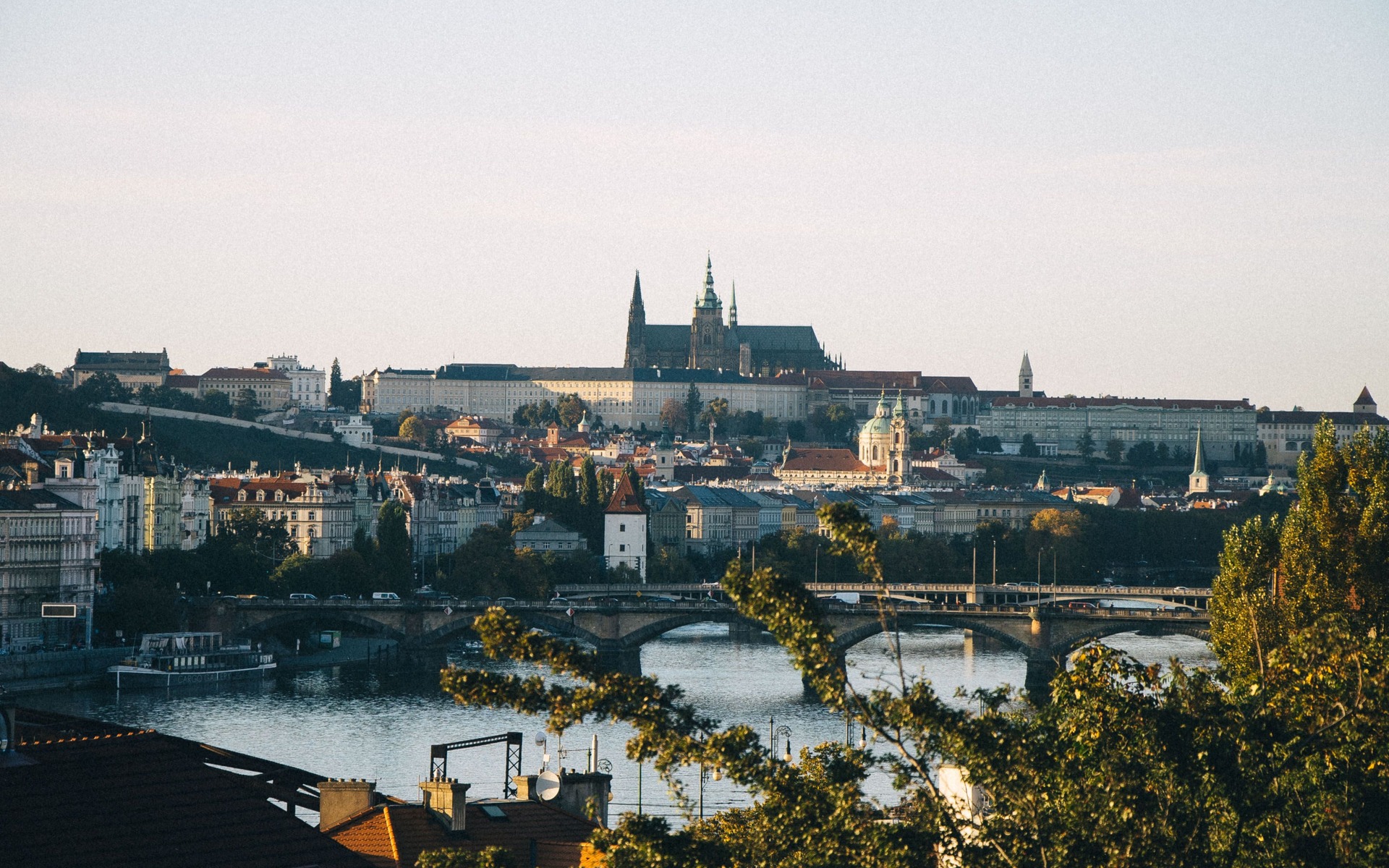 Capture of Prague Castle over Vltava River showcasing classic Czech architecture at dusk.