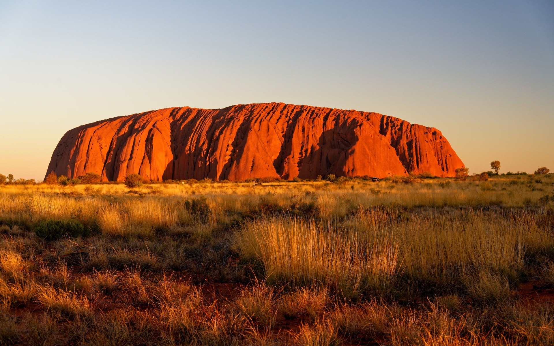Stunning view of Uluru, Australia's iconic rock formation, at sunrise in the Outback.