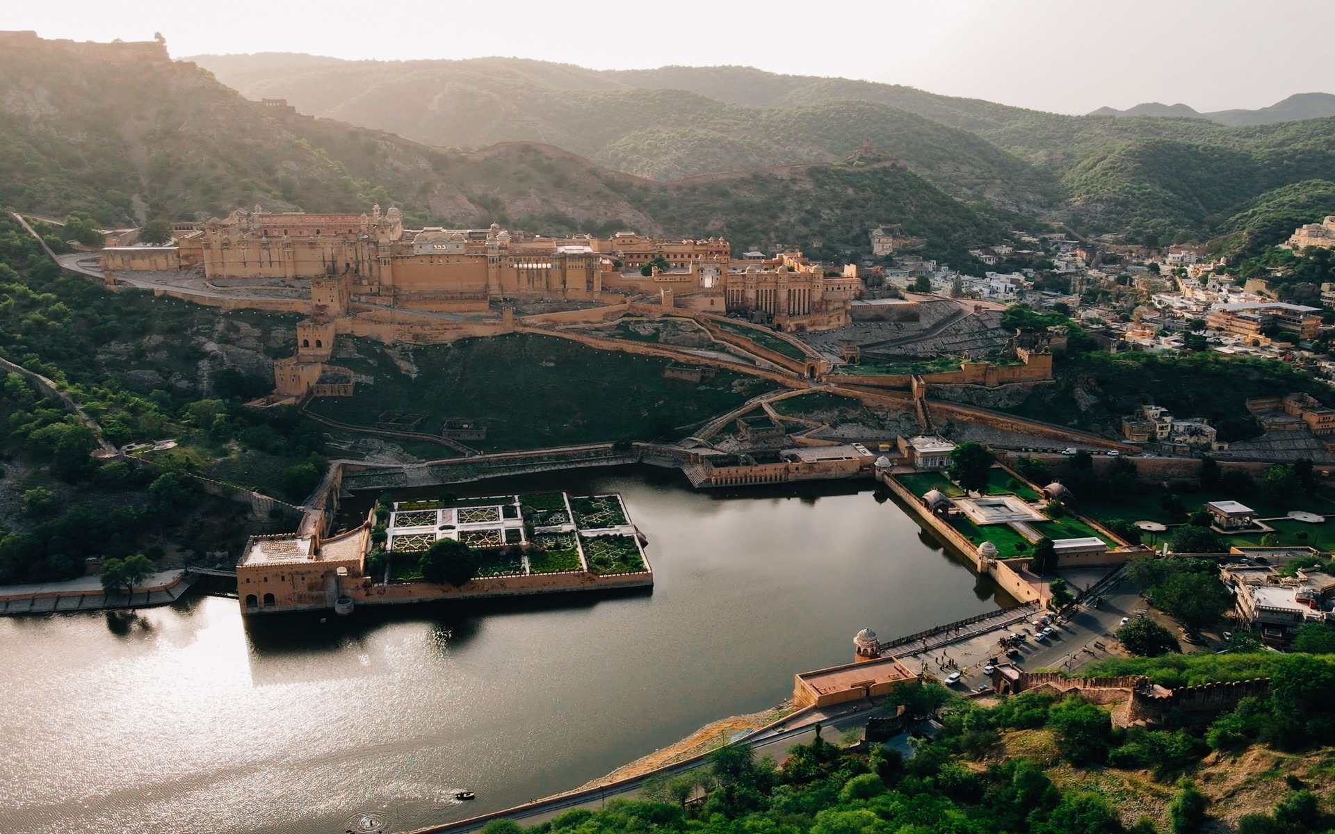 A breathtaking aerial view of Amber Fort, Jaipur with Maota Lake and scenic surroundings.