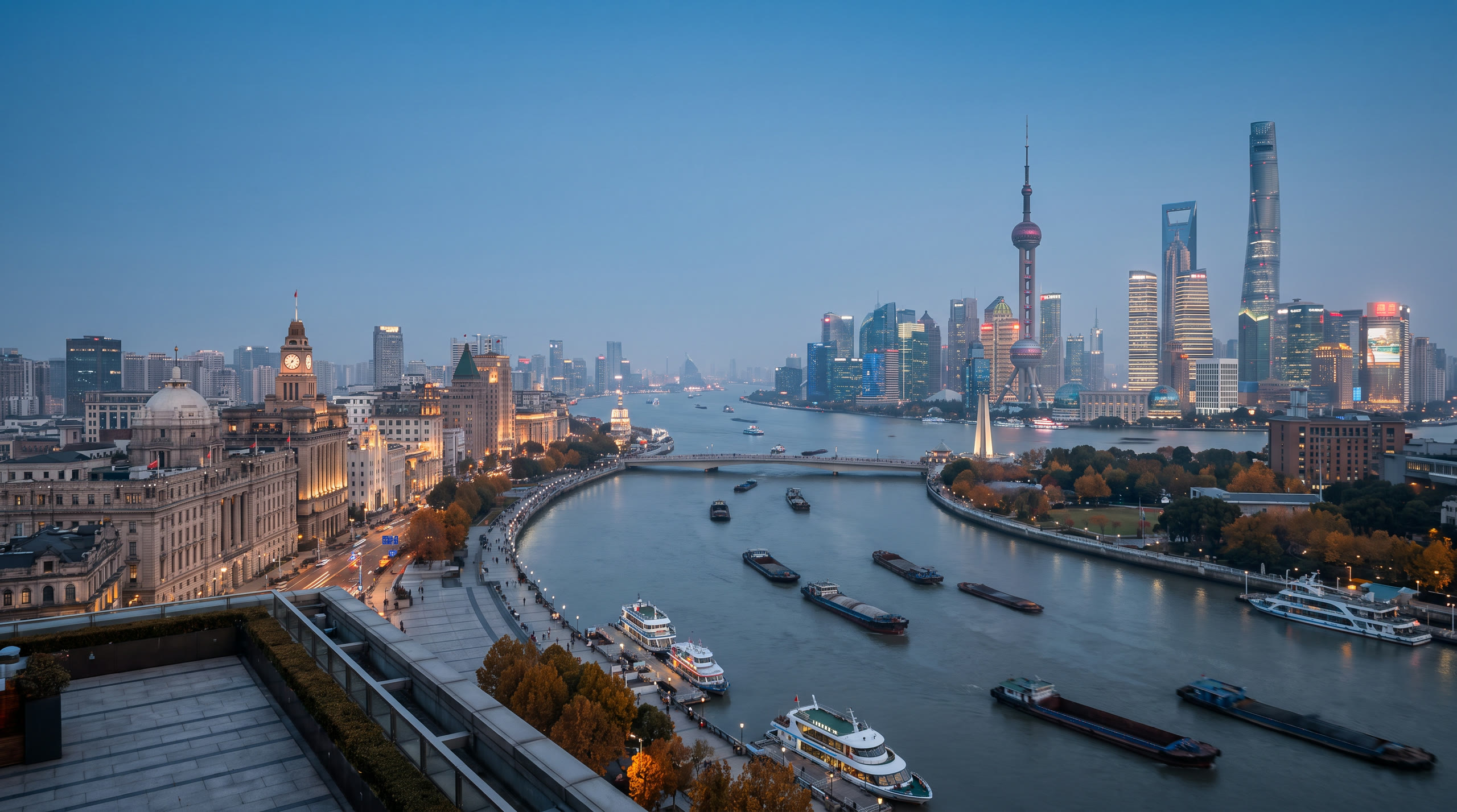 the Pudong skyline across the Huangpu from the Bund at Shanghai, China, in blue hour light — original Triple VIP destination visual.