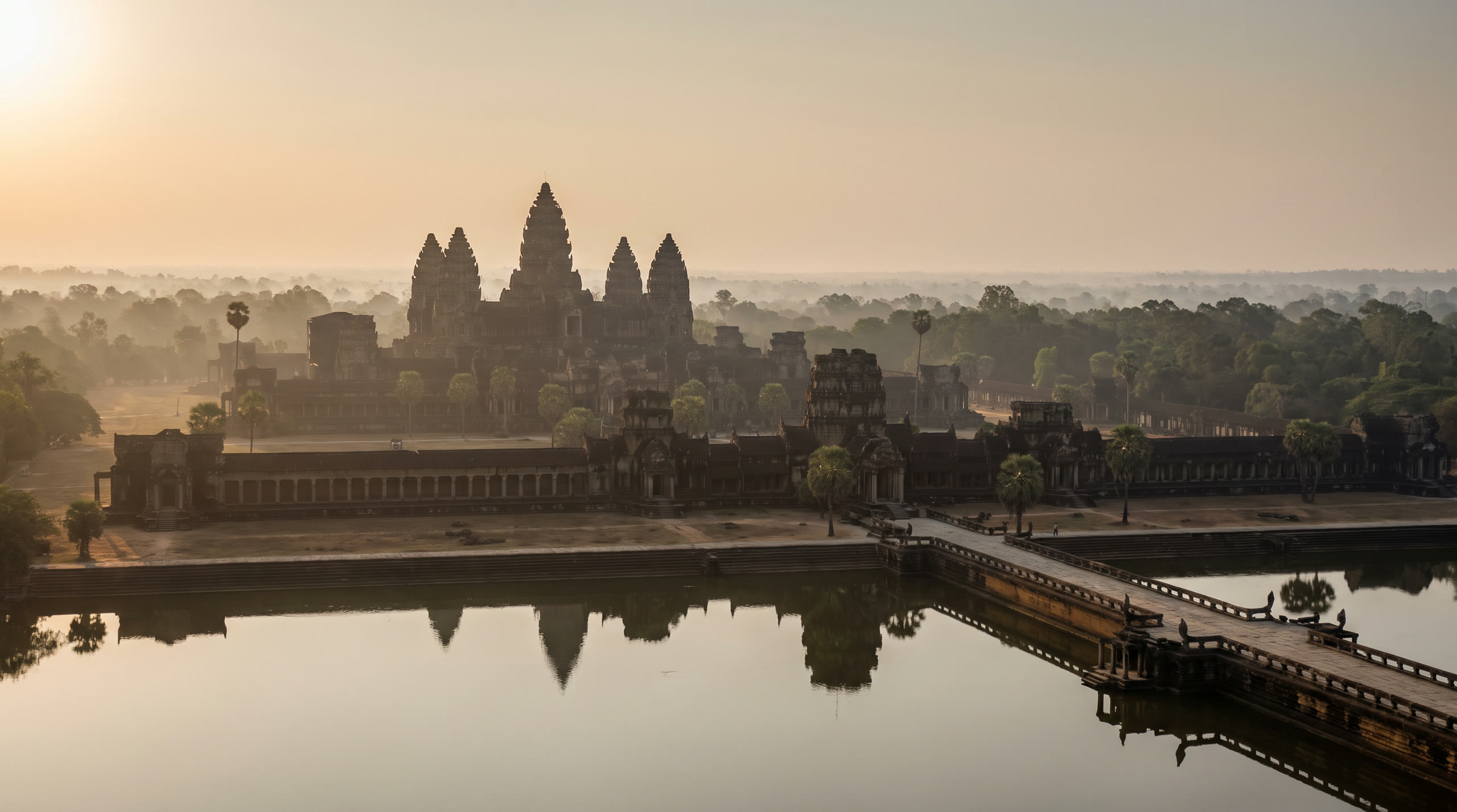 Angkor Wat's five lotus towers reflected in the moat at first light at Siem Reap & Angkor, Cambodia, in sunrise light — original Triple VIP destination visual.