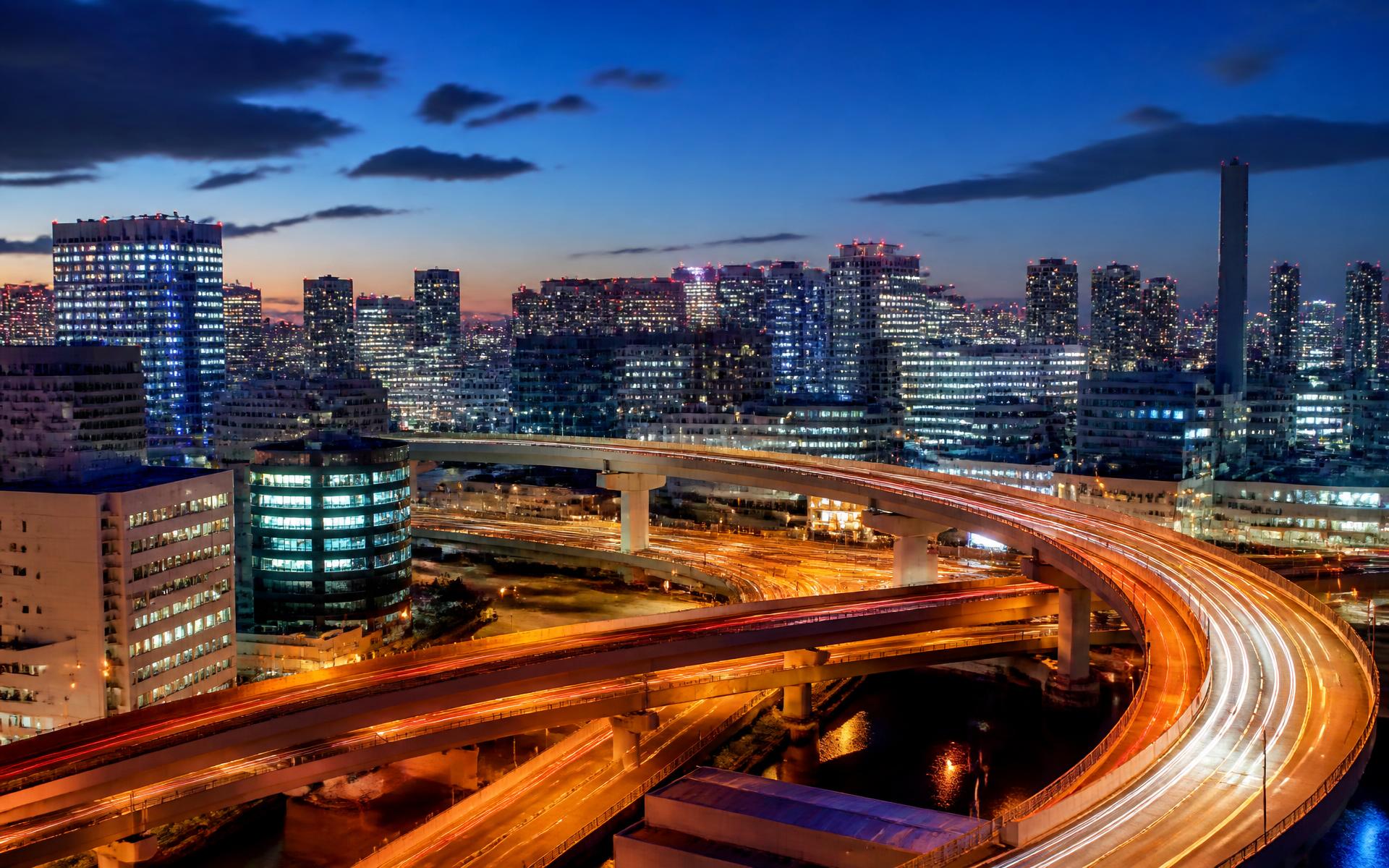 Illuminated expressways curving through the neon Tokyo cityscape at blue hour, Japan