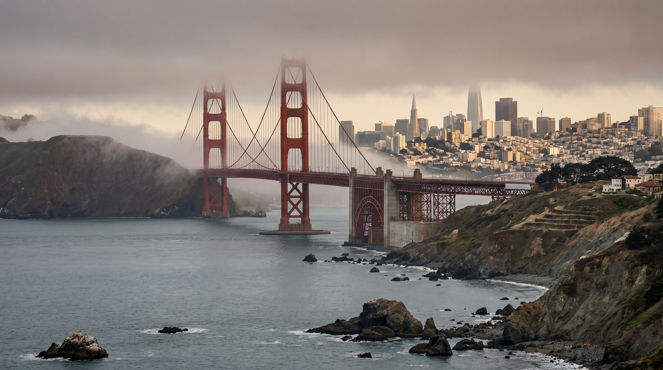 the bay with the Golden Gate's orange towers and the city hills behind at San Francisco, United States, in late afternoon light — original Triple VIP destination visual.