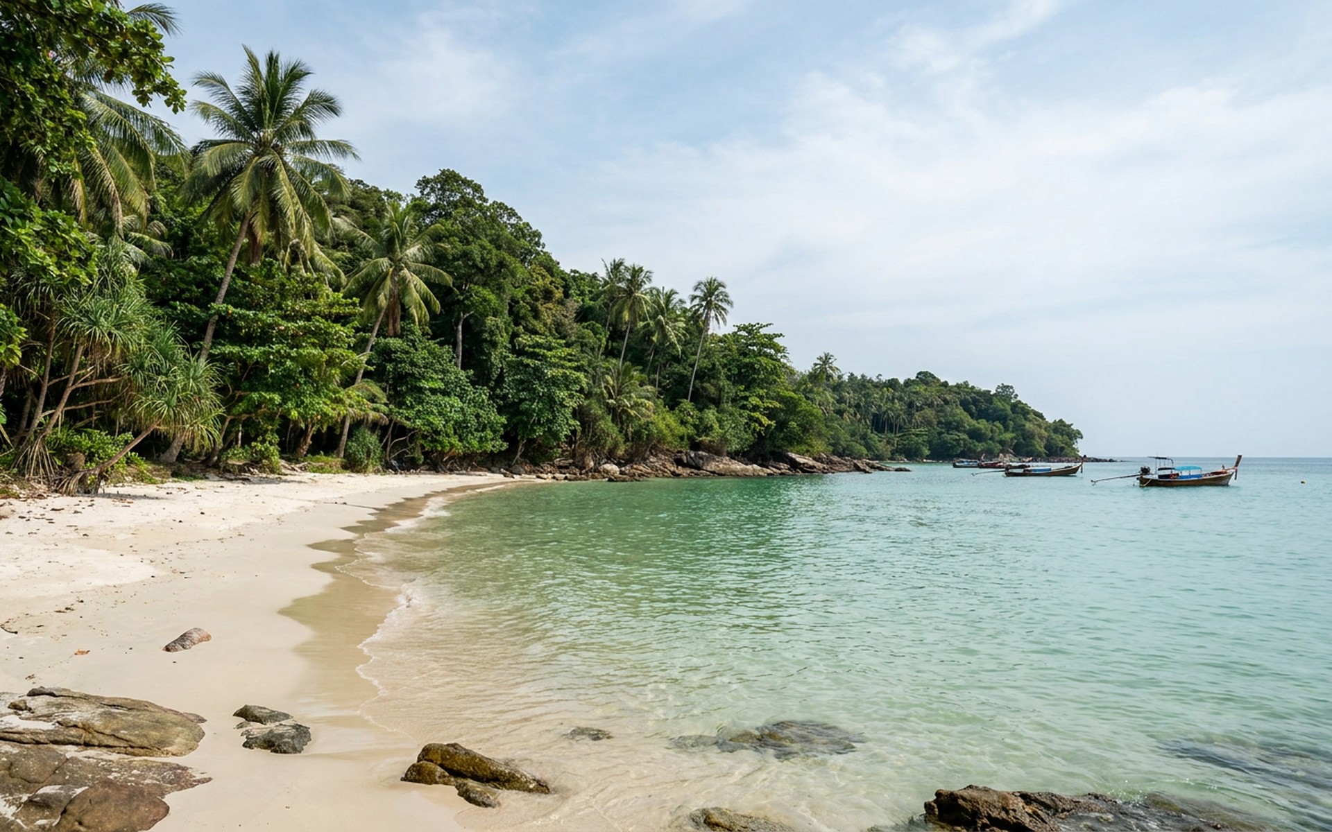 Secluded pristine white sand beach of Koh Kood, bordered by lush tropical jungle and overlooking the emerald calm waters of the Gulf of Thailand. at Koh Kood, Thailand — original Triple VIP destination visual.