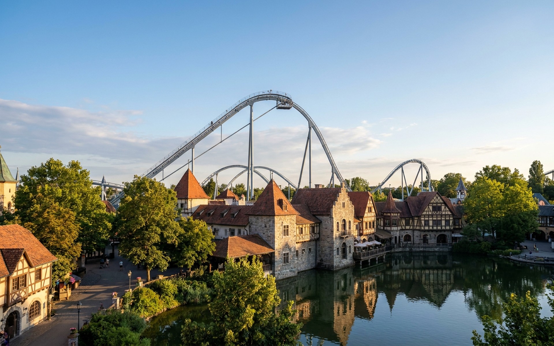 The iconic Silver Star rollercoaster soaring above the European-themed architecture of Europa-Park, bathed in vibrant late afternoon summer light. at Rust & Europa-Park, Germany — original Triple VIP destination visual.