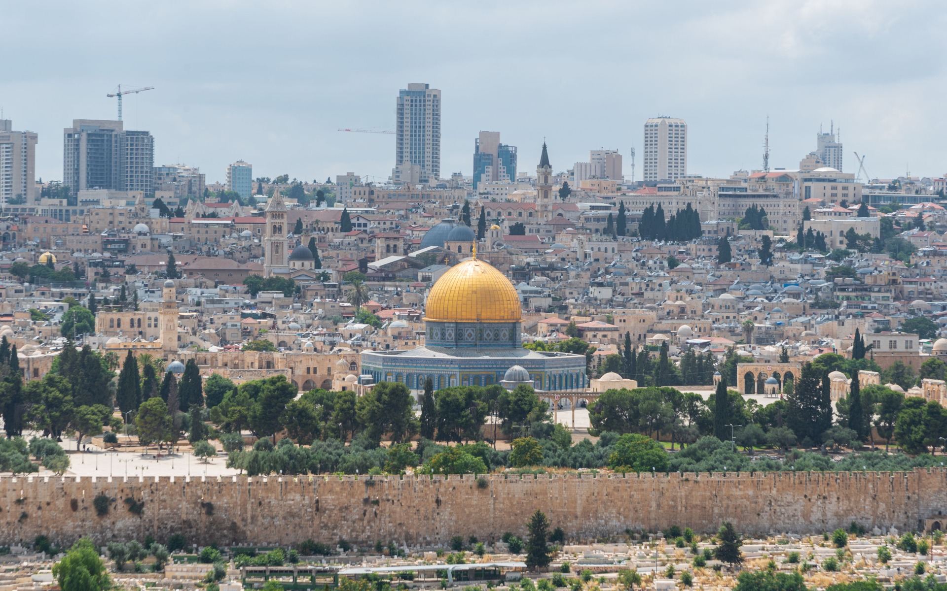 Captivating aerial view of the Dome of the Rock with Jerusalem's skyline in the background.