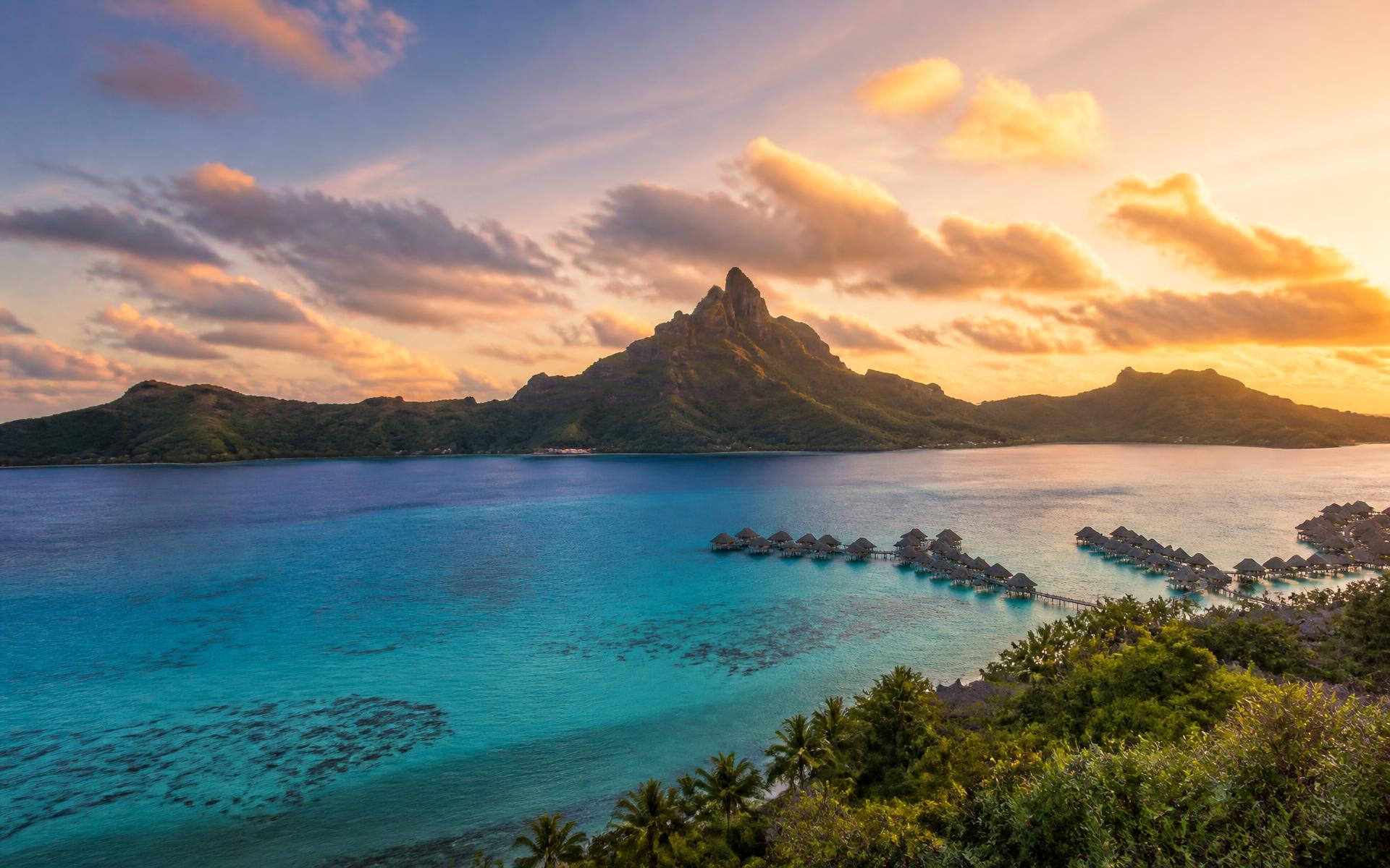 Turquoise lagoon, coral reef and volcanic peak at sunset in Bora Bora, French Polynesia