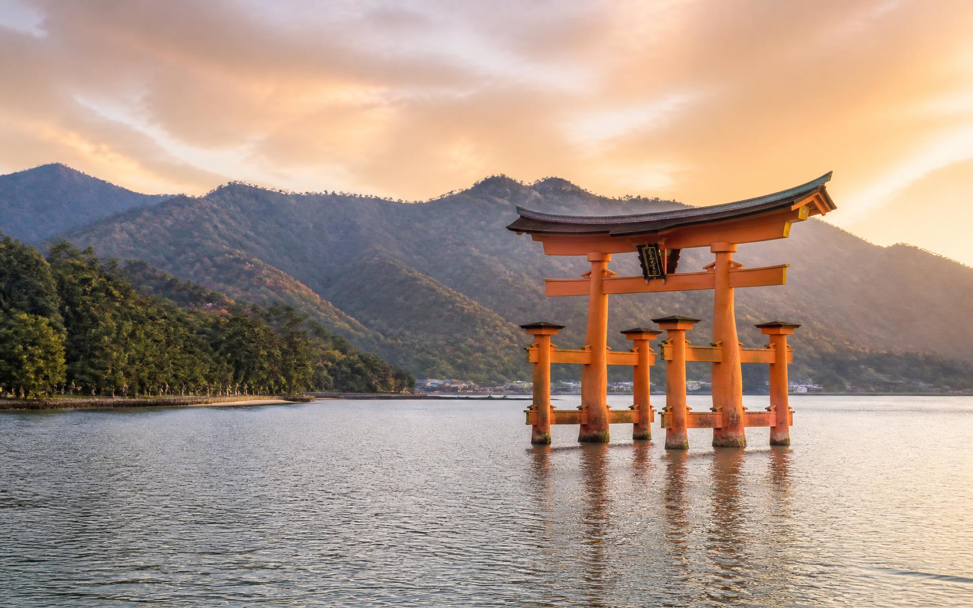 the great vermilion floating torii gate standing in the sea at high tide at Miyajima, Japan — original Triple VIP destination visual.