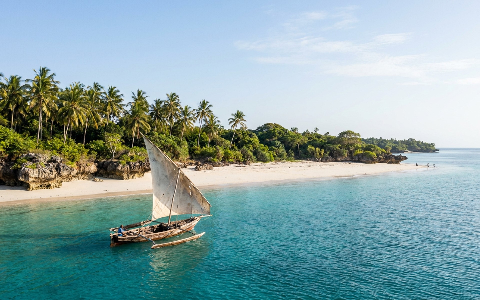 A traditional dhow sailing across turquoise waters, fringed by pristine white sand beaches and lush green palm trees under a bright tropical morning sun. at Pemba Island, Tanzania — original Triple VIP destination visual.