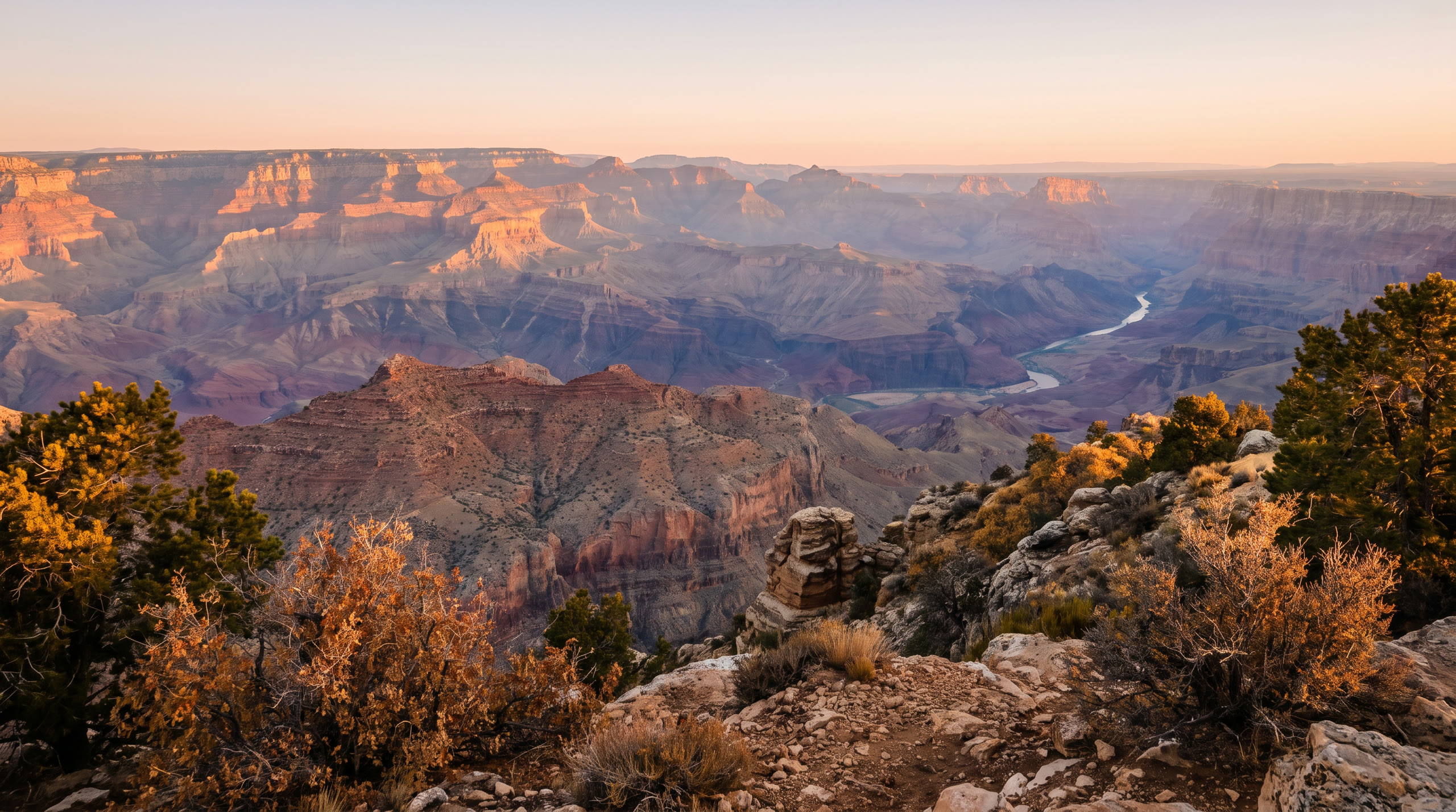 layered canyon walls receding in atmospheric bands to the inner gorge at Grand Canyon Region, United States, in sunrise light — original Triple VIP destination visual.