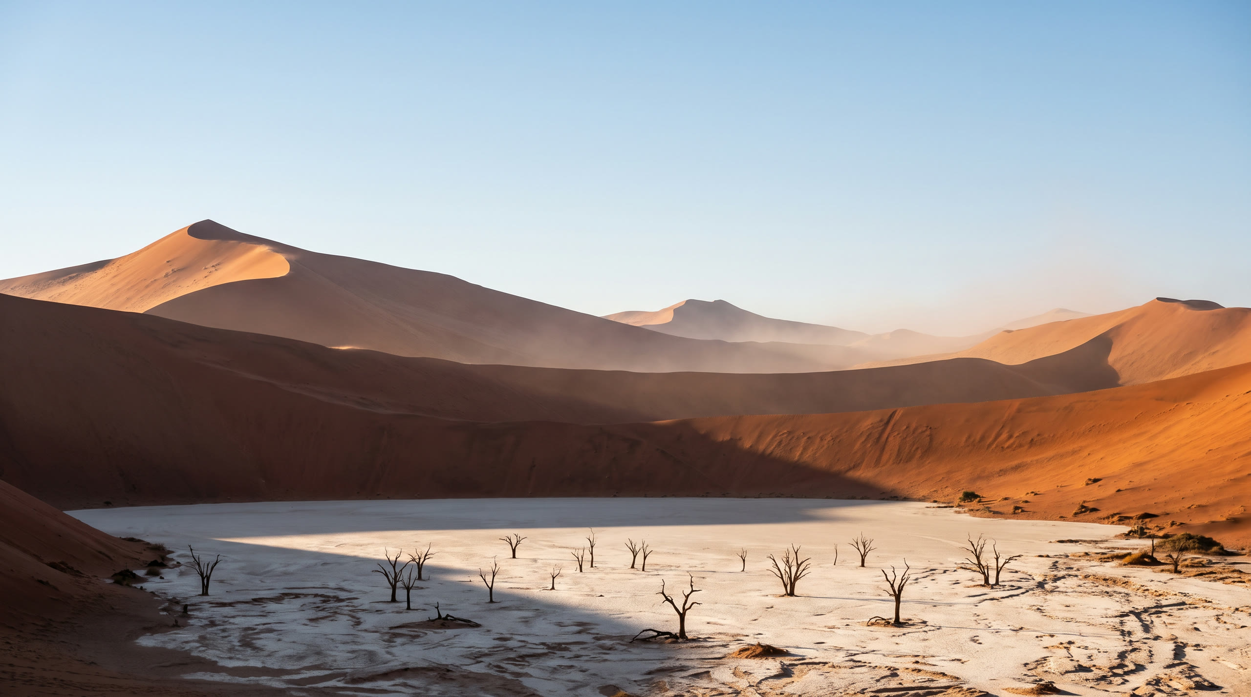 towering rust-red star dunes with a bleached clay pan and dead camelthorn trees at Sossusvlei & Namib Desert, Namibia, in sunrise light — original Triple VIP destination visual.