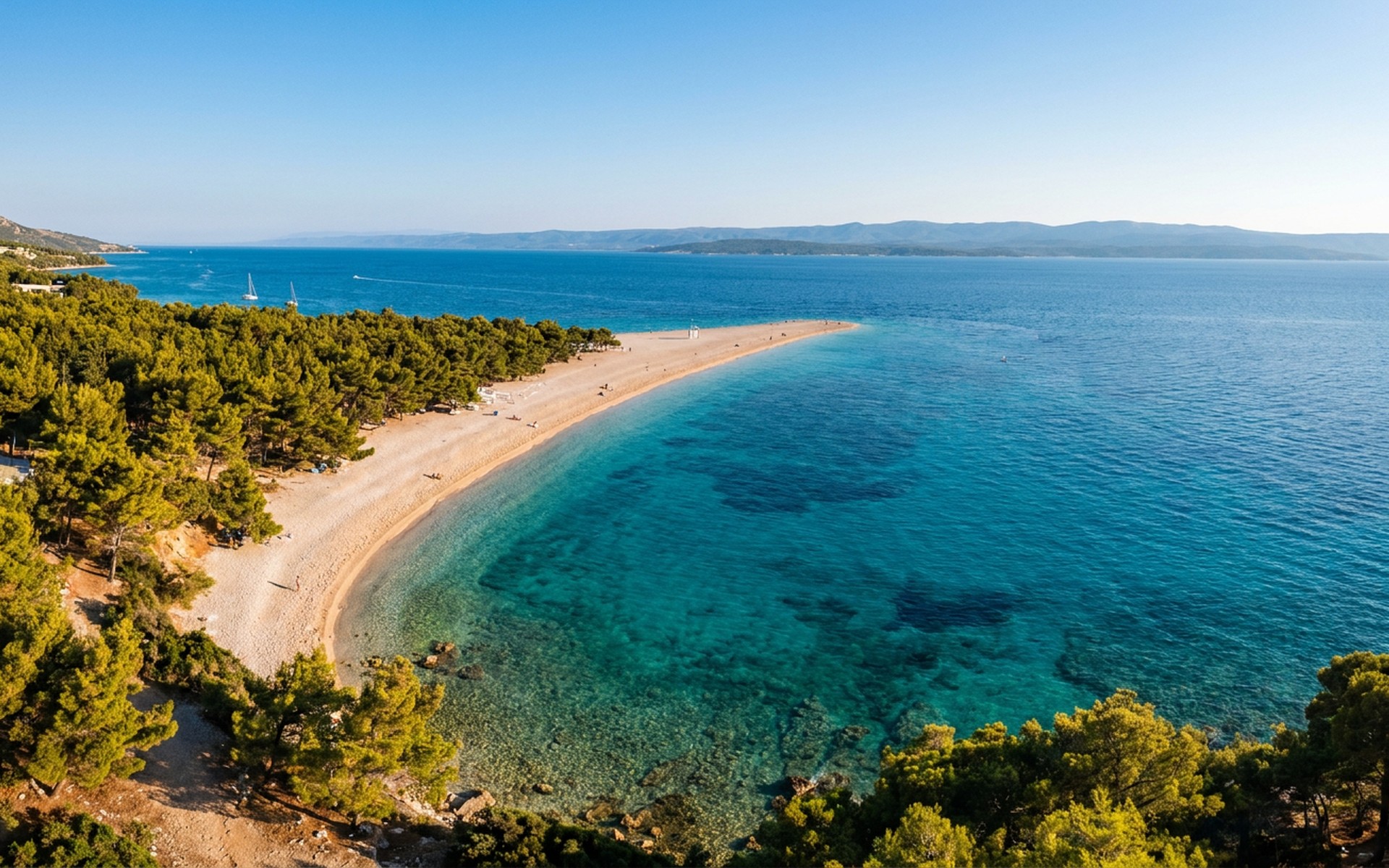 Aerial view of Zlatni Rat (Golden Horn) beach, a unique V-shaped pebble beach extending into the Adriatic Sea on Brač Island, bathed in summer light. at Brač, Croatia — original Triple VIP destination visual.