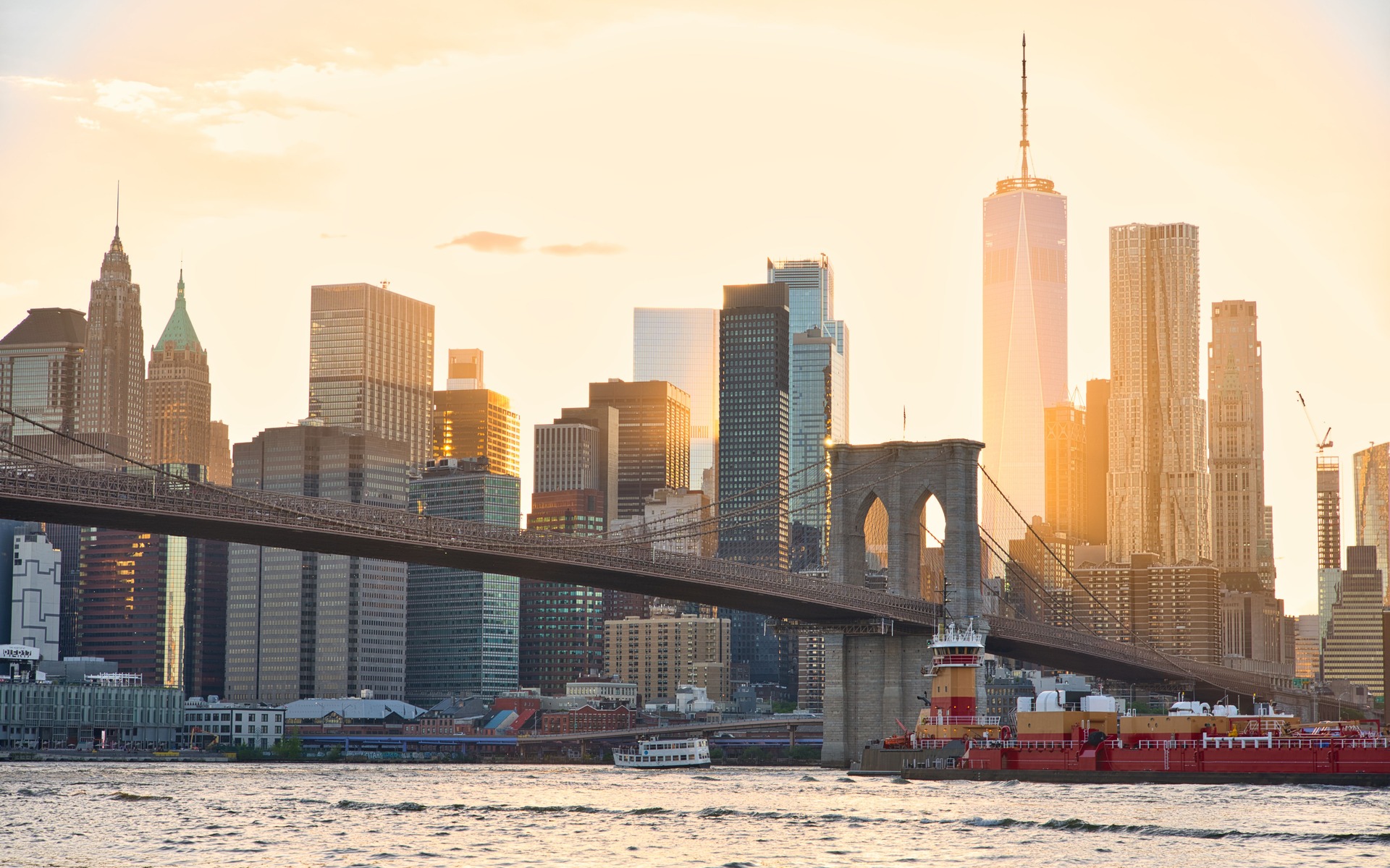 A stunning view of the Brooklyn Bridge and New York City's skyline at sunset.