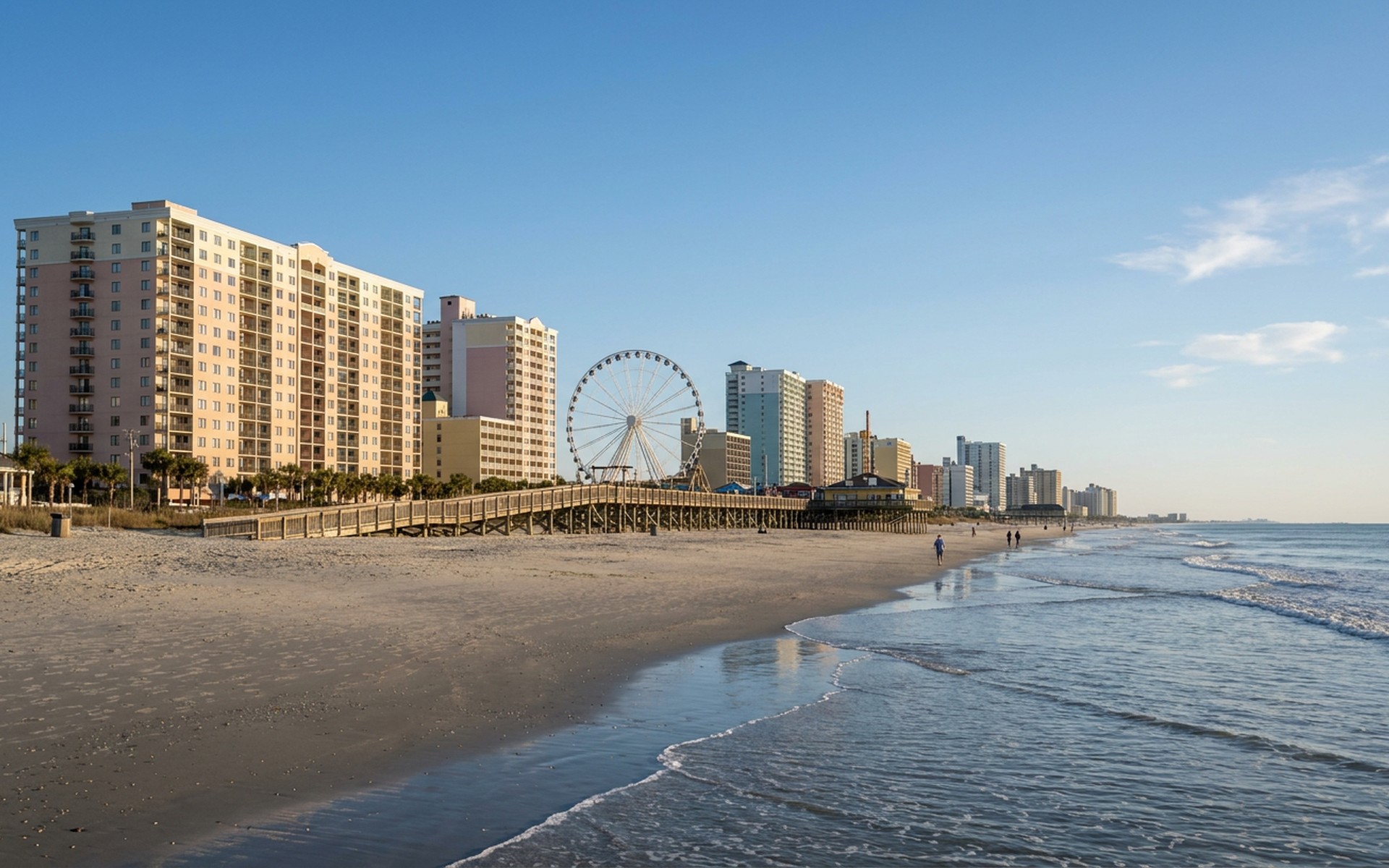 Expansive sandy Myrtle Beach shoreline with gentle Atlantic waves and a clear blue sky, featuring the iconic boardwalk in the distance. at Myrtle Beach, United States — original Triple VIP destination visual.